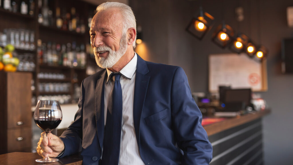 Business man who is a high functioning alcoholic drinking in a bar. in bar