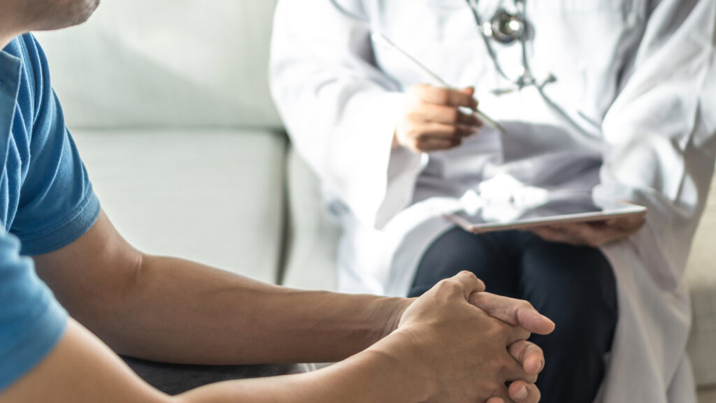 Doctor evaluating a patient who suffers from addiction for detox admission.