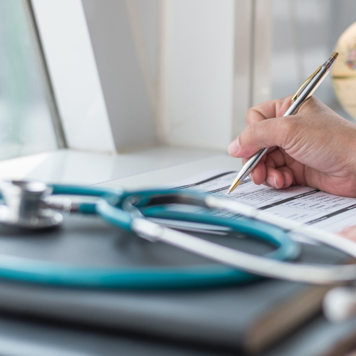 Doctor filling out paperwork