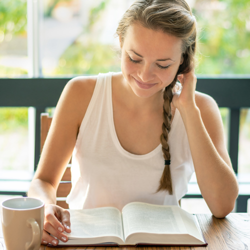 Happy woman studying a book