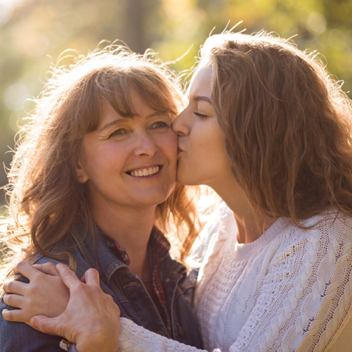 Smiling mother and adult daughter