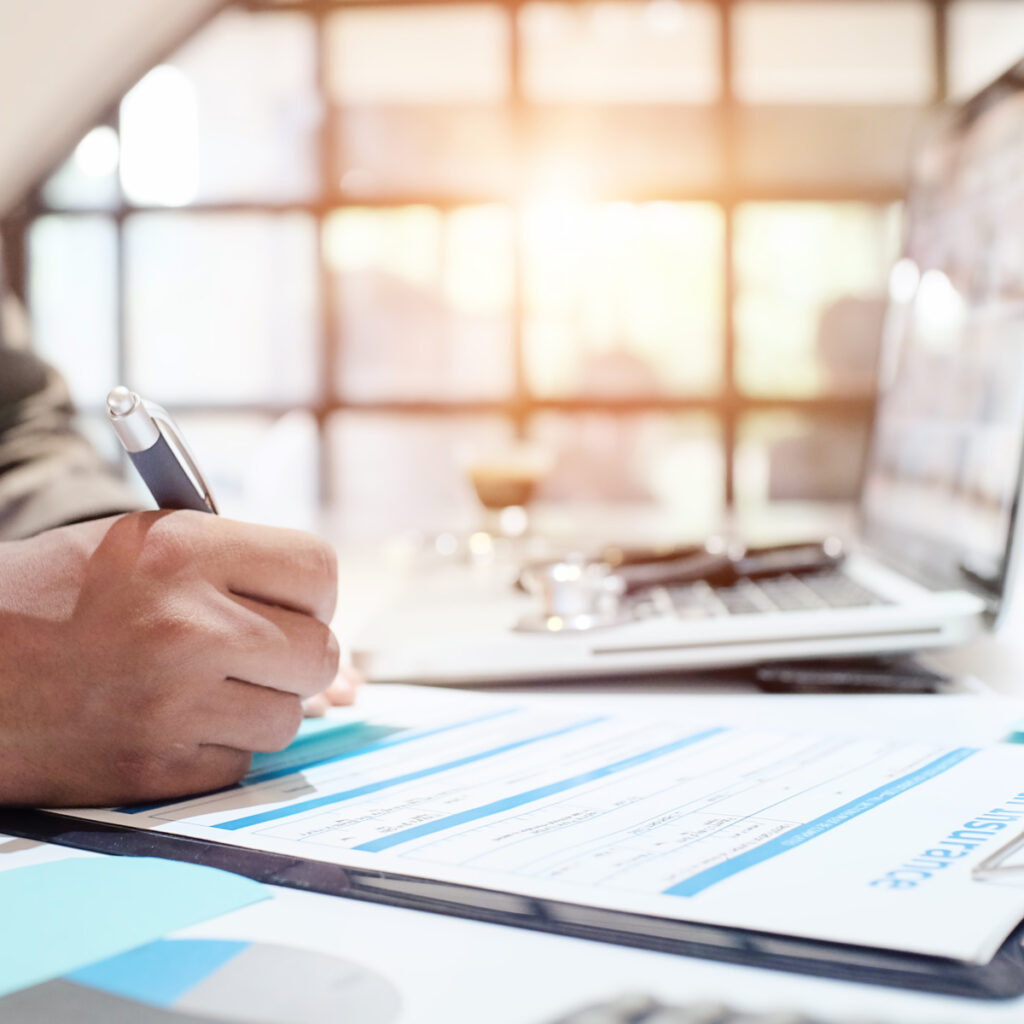 person filling out insurance paperwork